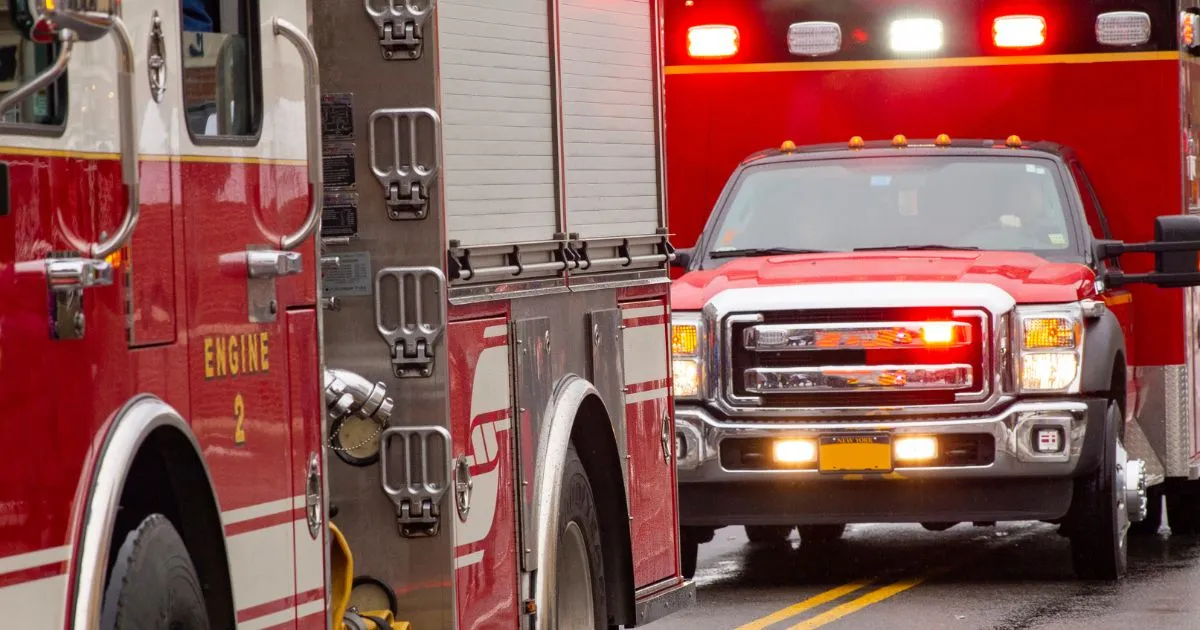 Ambulance following a fire truck to help the victims of an accident.
